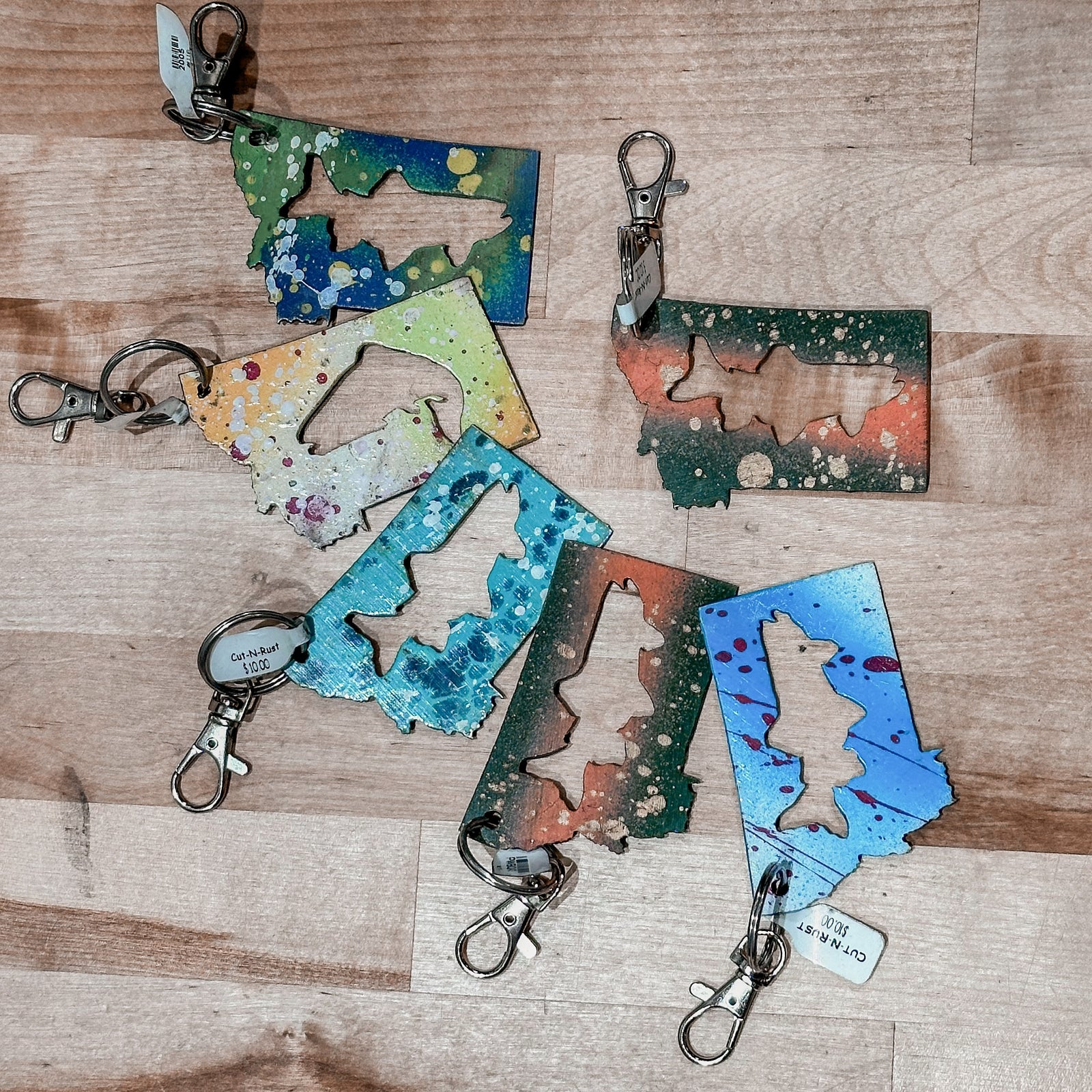 This made in Montana Trout Metal Keychain showcases a state-shaped design with a trout cut out of it.