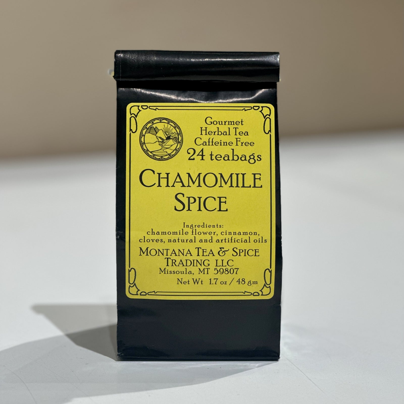 A black bag with a yellow label reading Chamomile Spice and Montana Tea and Spice Trading LLC