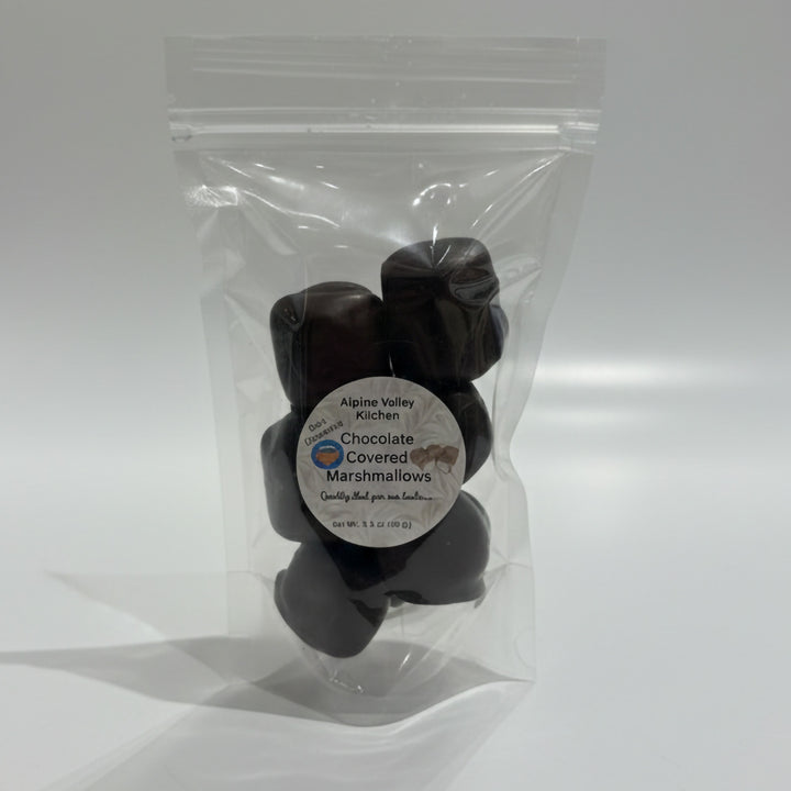 Clear plastic bag with chocolate-covered marshmallows and a label on a white background