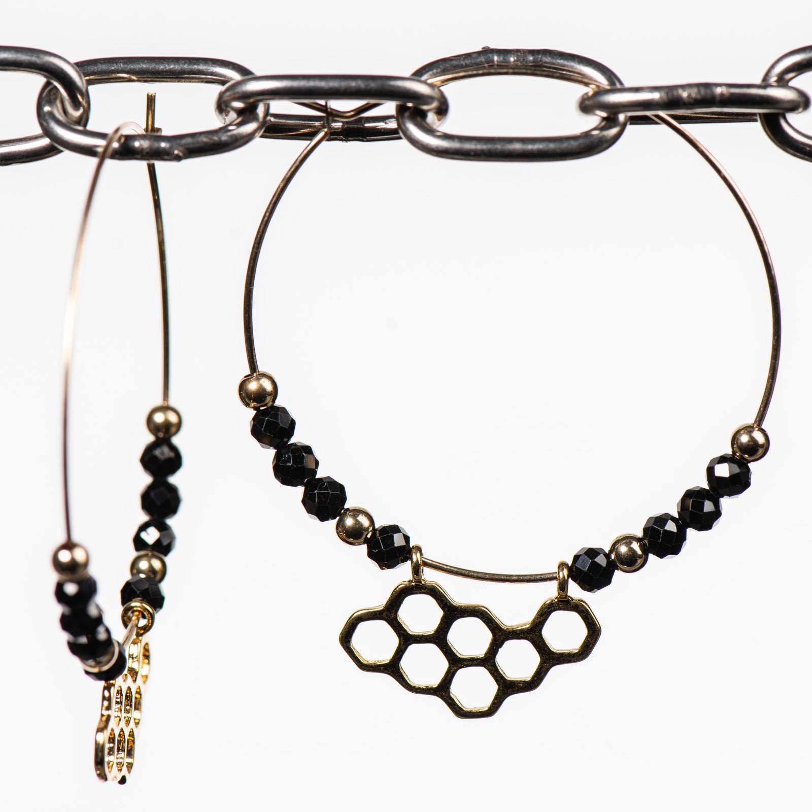 Cobblestone Designs of Montana's Honeycomb Earrings--fine metal (sterling silver) honeycomb dangle and black spiral stones on an elegant gold filled hoop, handcrafted in Montana