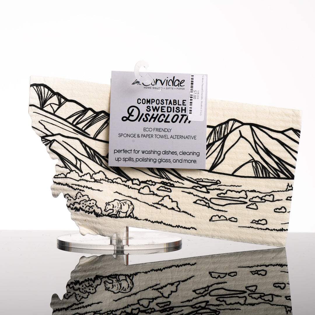 Montana Shaped Swedish Dishcloth depicting a mountain range, and a grizzly bear in a meadow - eco friendly sponge and paper towel alternative made in Montana by Corvidae