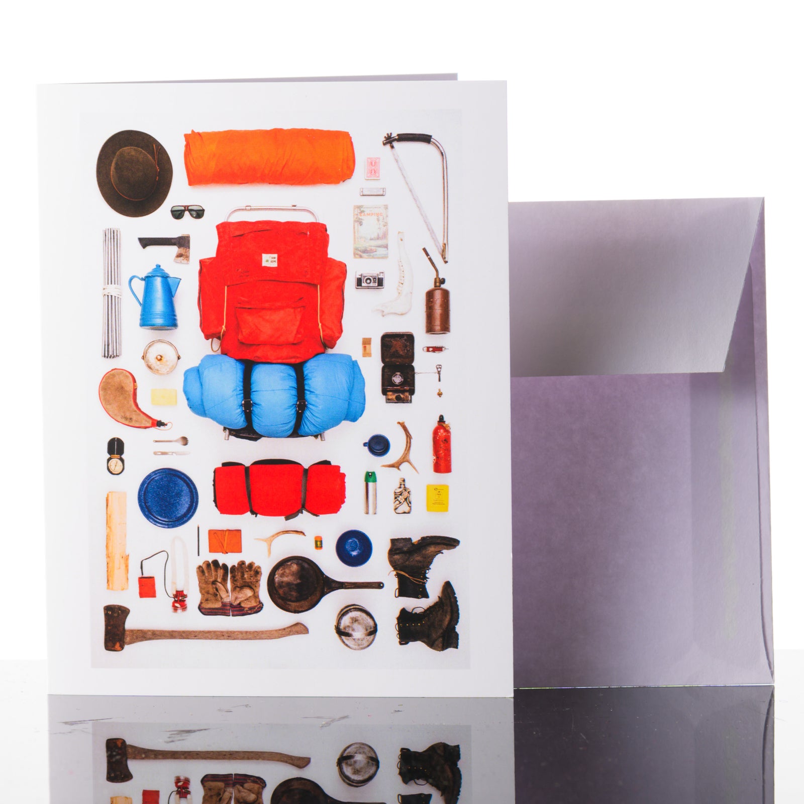 A flat lay photograph greeting card of adventure camping gear.