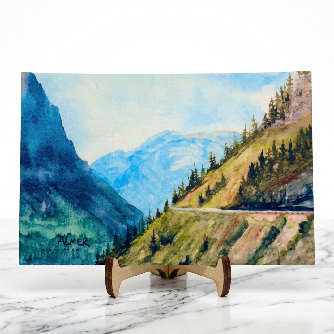 Capture Montana’s beauty with the Going to the Sun Postcard by Stark Mountain Studio, featuring Bobbe Almer watercolor art of Glacier National Park.