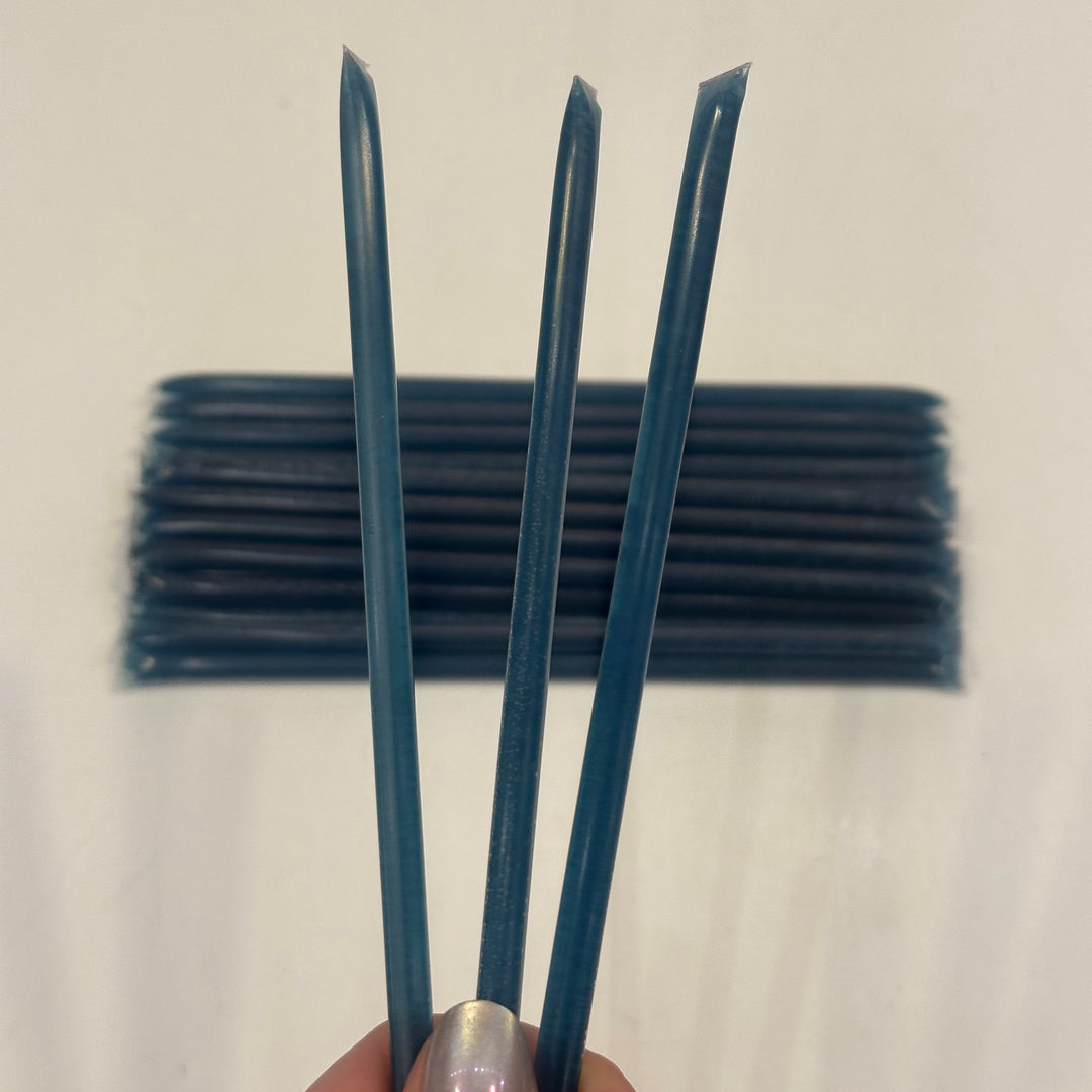 Three dark blue grape flavored Honey Sticks made in Montana