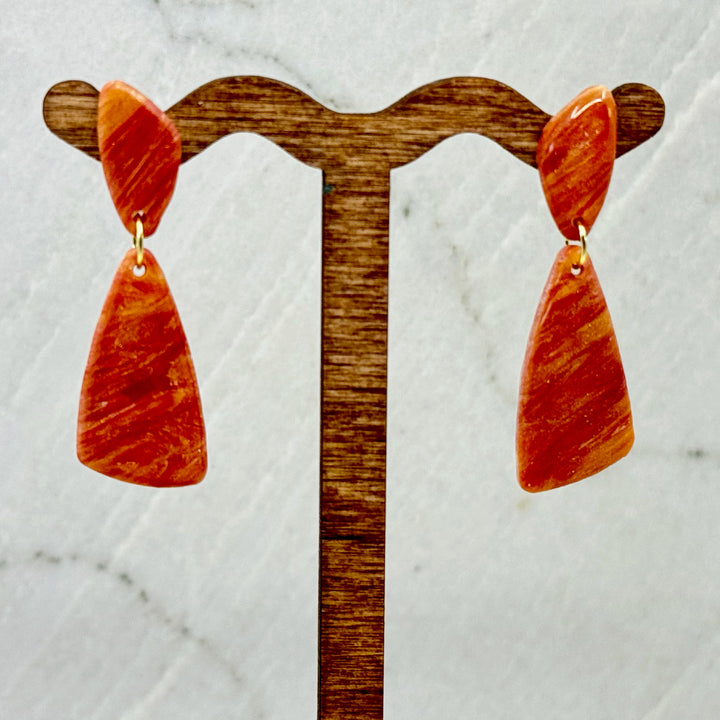 Pair of Abstract Earrings by Bitterroot Shining Creations (orange), hanging