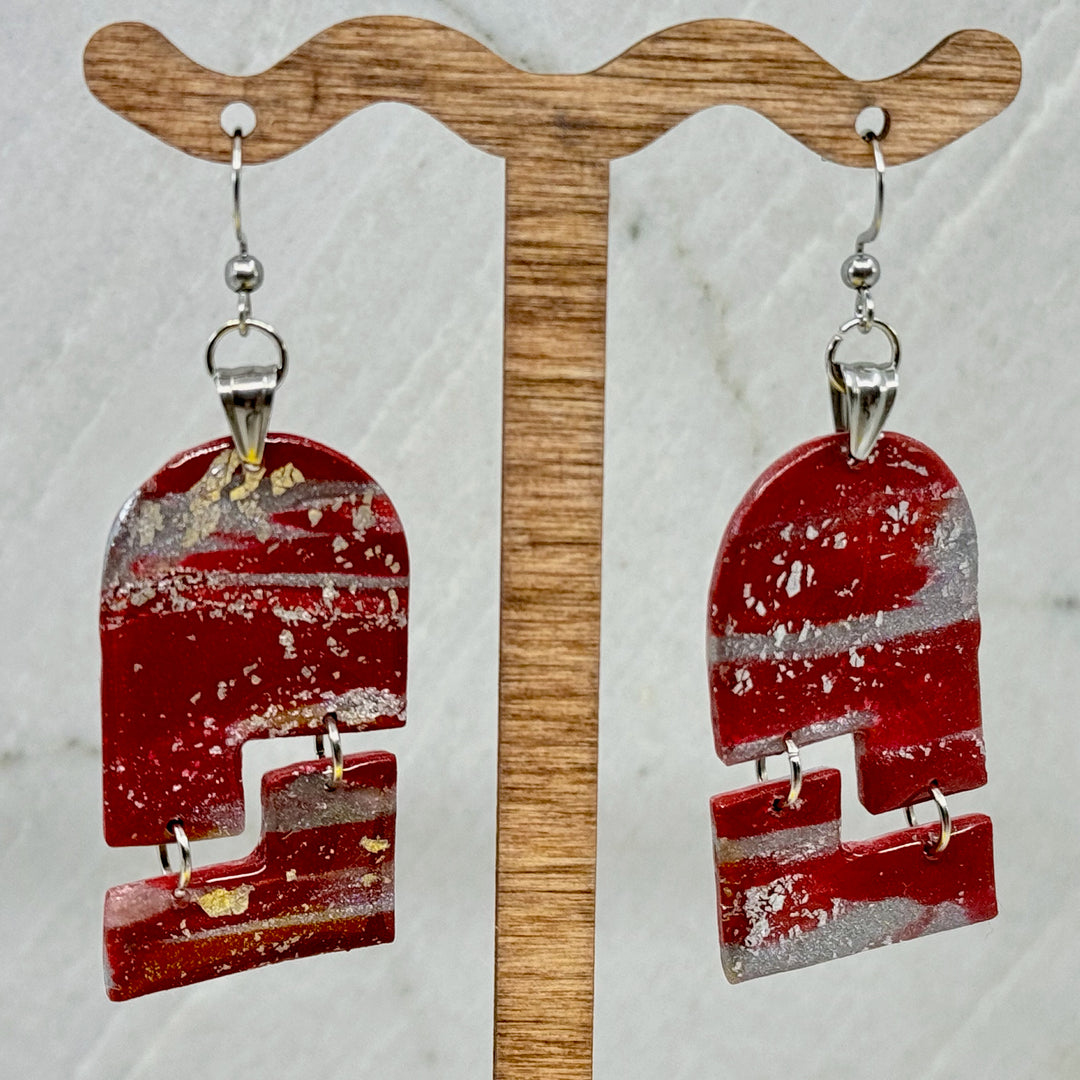 Pair of Abstract Earrings (University of MT Grizzlies Themed) made with maroon and silver polymer clay, by Bitterroot Shining Creations (arches), hanging