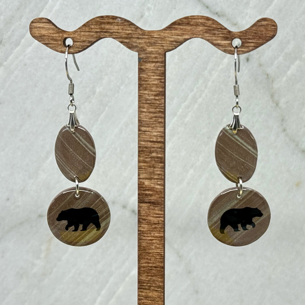 Pair of Small Dangle Earrings with Bears by Bitterroot Shining Creations, featuring double drop polymer clay in in various colors with a bear silhouette on the bottom drop (taupe), hanging