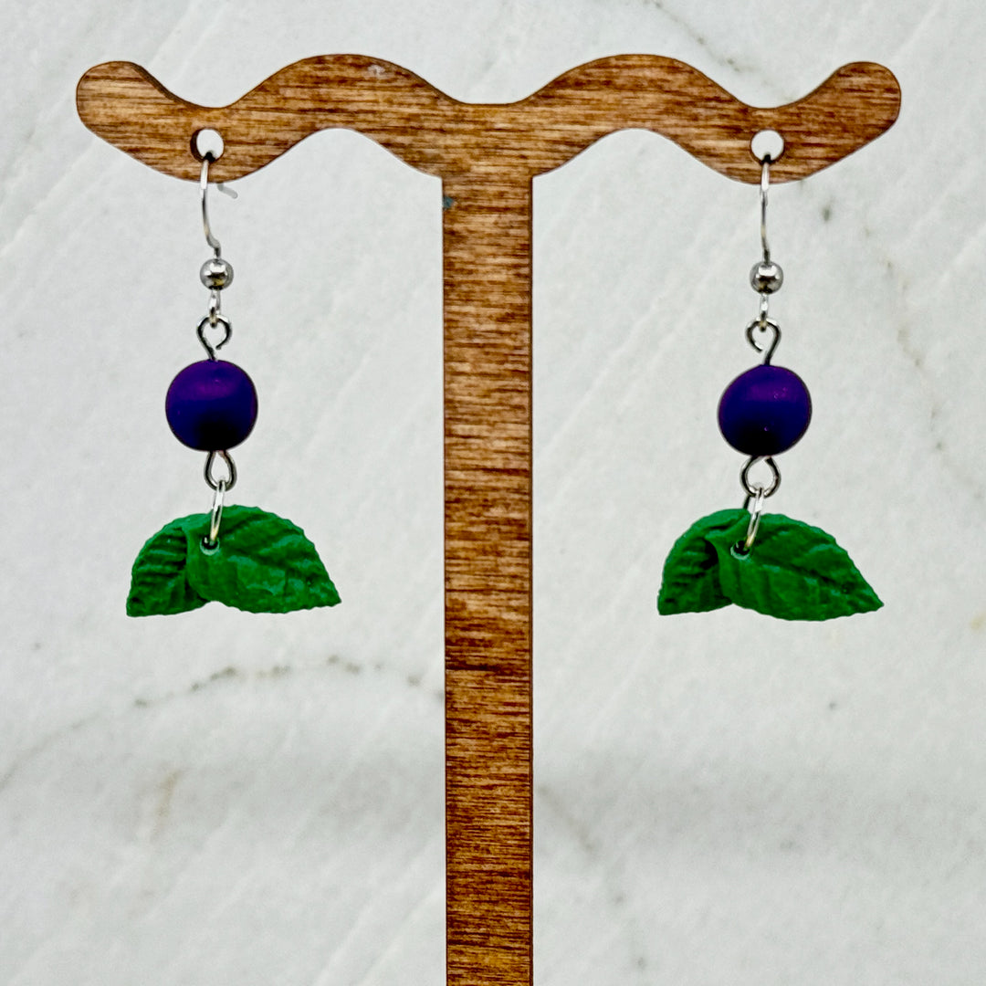 Pair of polymer clay Huckleberry Earrings on stainless steel ear wires by Bitterroot Shining Creations (single berry design), hanging