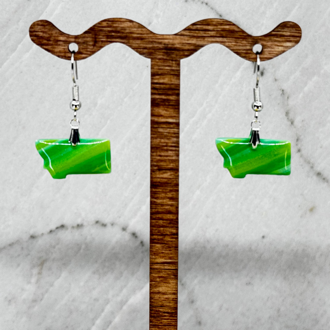 Pair of small, polymer clay Montana Earrings by Bitterroot Shining Creations in assorted sparkly colors (green), hanging