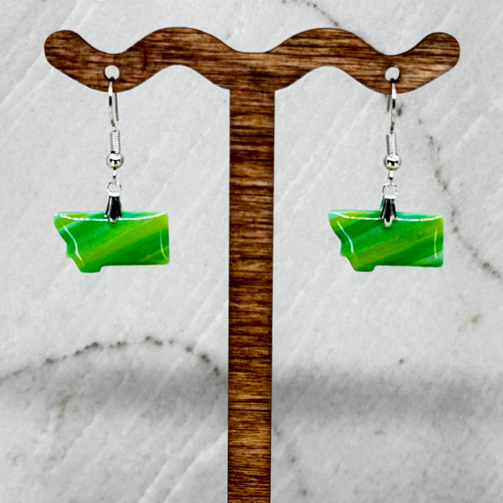 Pair of small, polymer clay Montana Earrings by Bitterroot Shining Creations in assorted sparkly colors (green), hanging