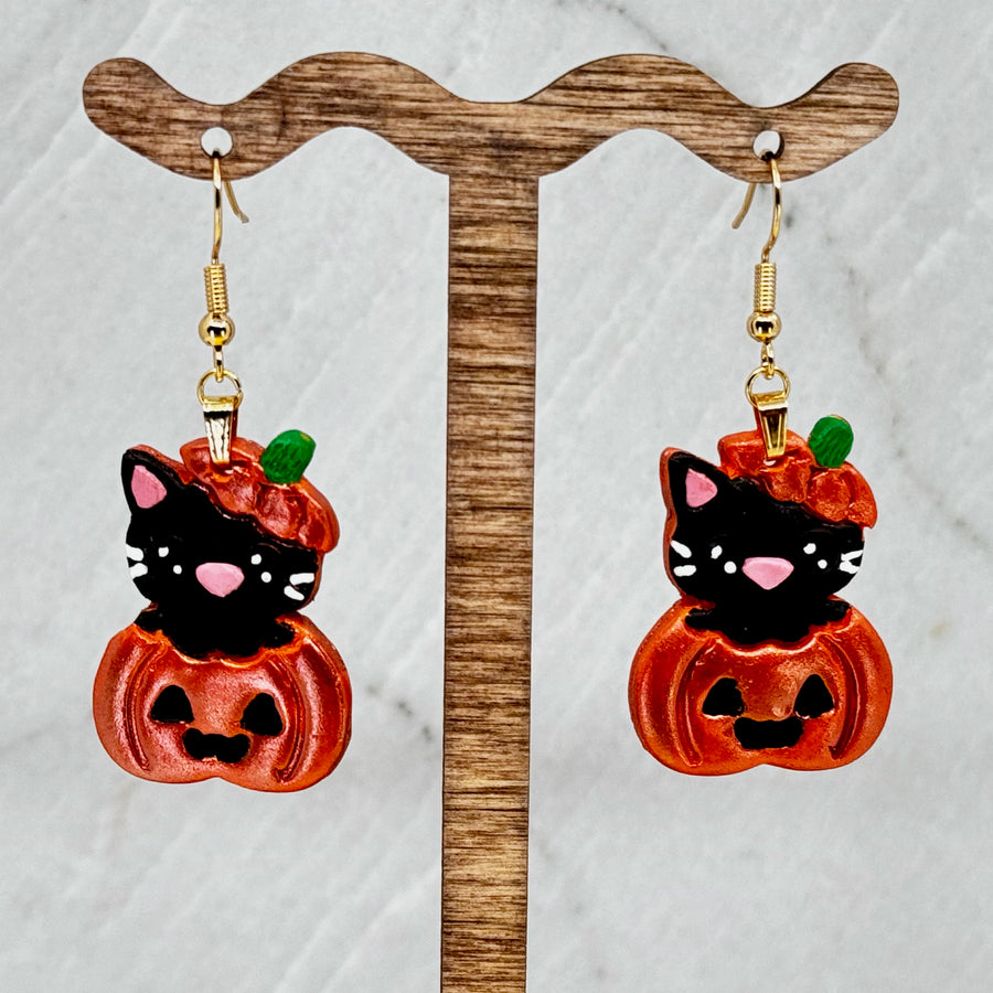 Pair of Pumpkin Cat Earrings featuring polymer clay black cats emerging from sparkly orange pumpkins, hanging
