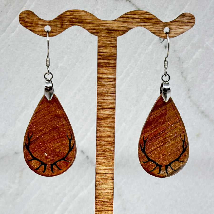 Pair of Large Teardrop Earrings with Antlers, featuring shimmering gold polymer clay teardrops decorated with black antlers, hanging