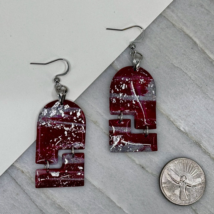 Pair of Abstract Earrings (University of MT Grizzlies Themed) made with maroon and silver polymer clay, by Bitterroot Shining Creations (arches), with scale
