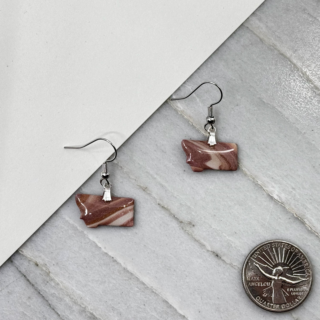 Pair of small, polymer clay Montana Earrings by Bitterroot Shining Creations in assorted sparkly colors (dusty rose), with scale