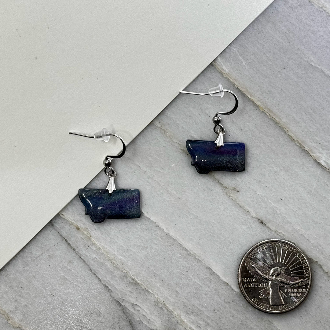 Pair of small, polymer clay Montana Earrings by Bitterroot Shining Creations in assorted sparkly colors (night sky), with scale