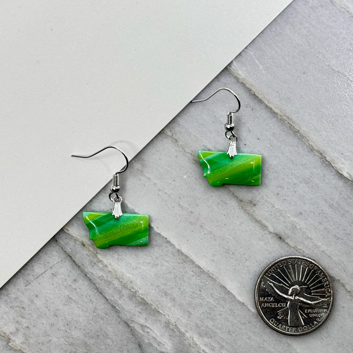 Pair of small, polymer clay Montana Earrings by Bitterroot Shining Creations in assorted sparkly colors (green), with scale