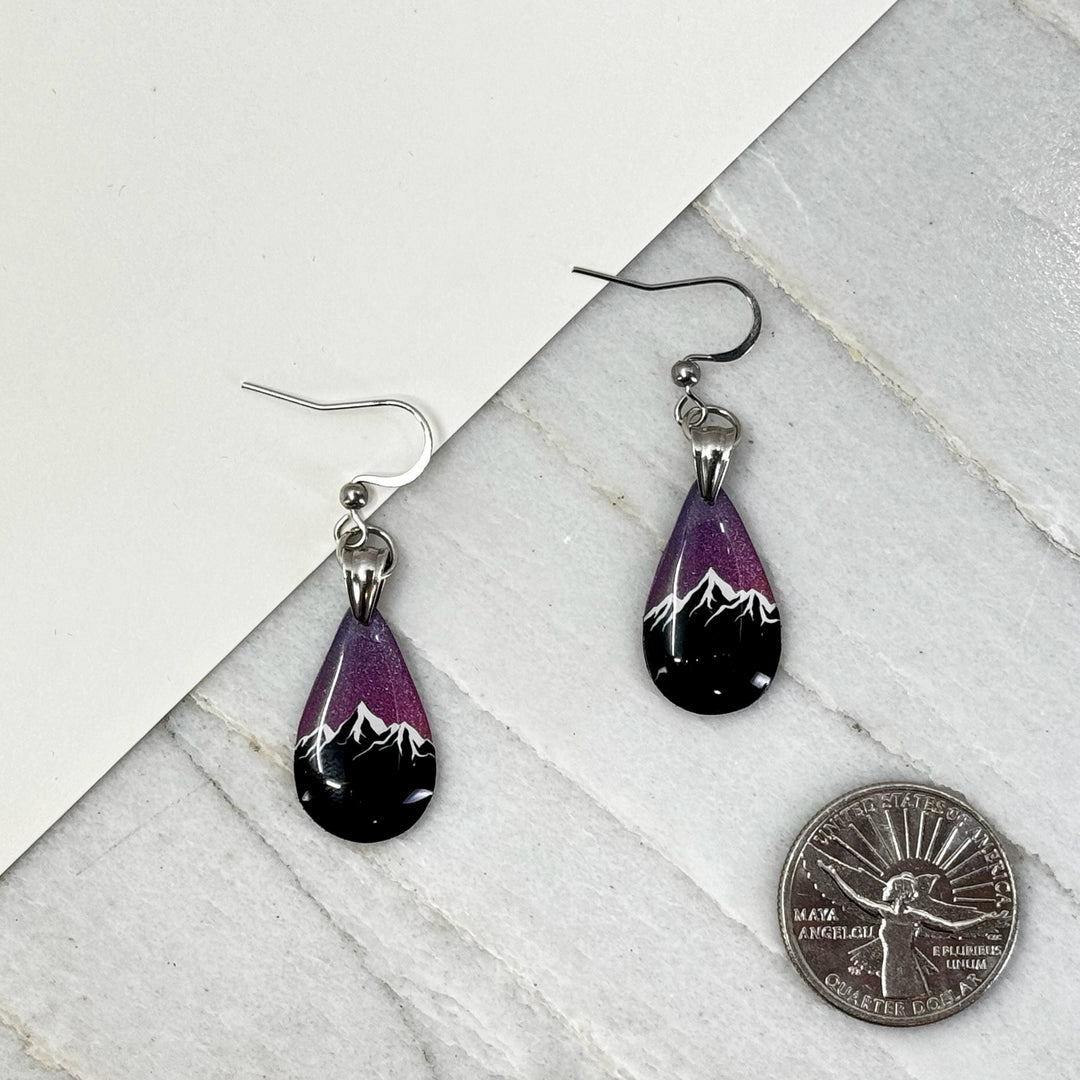 Pair of small, polymer clay Teardrop Earrings with Mountain by Bitterroot Shining Creations (sparkly purple), with scale