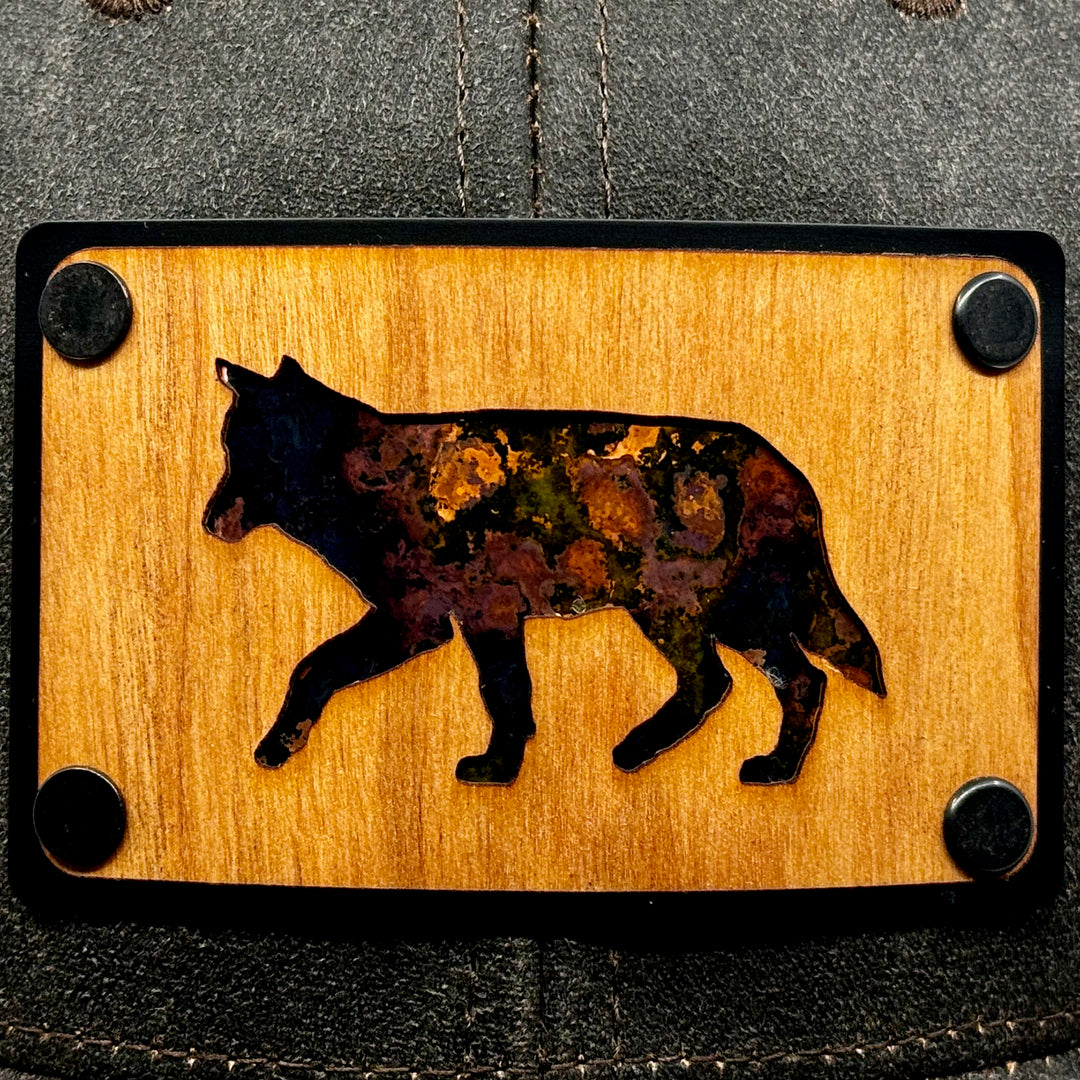 Last Best Supply Co's Cherry Wood & Green Copper Wolf Patch Plate Mossy Oak Trucker Hat (patch detail 1)
