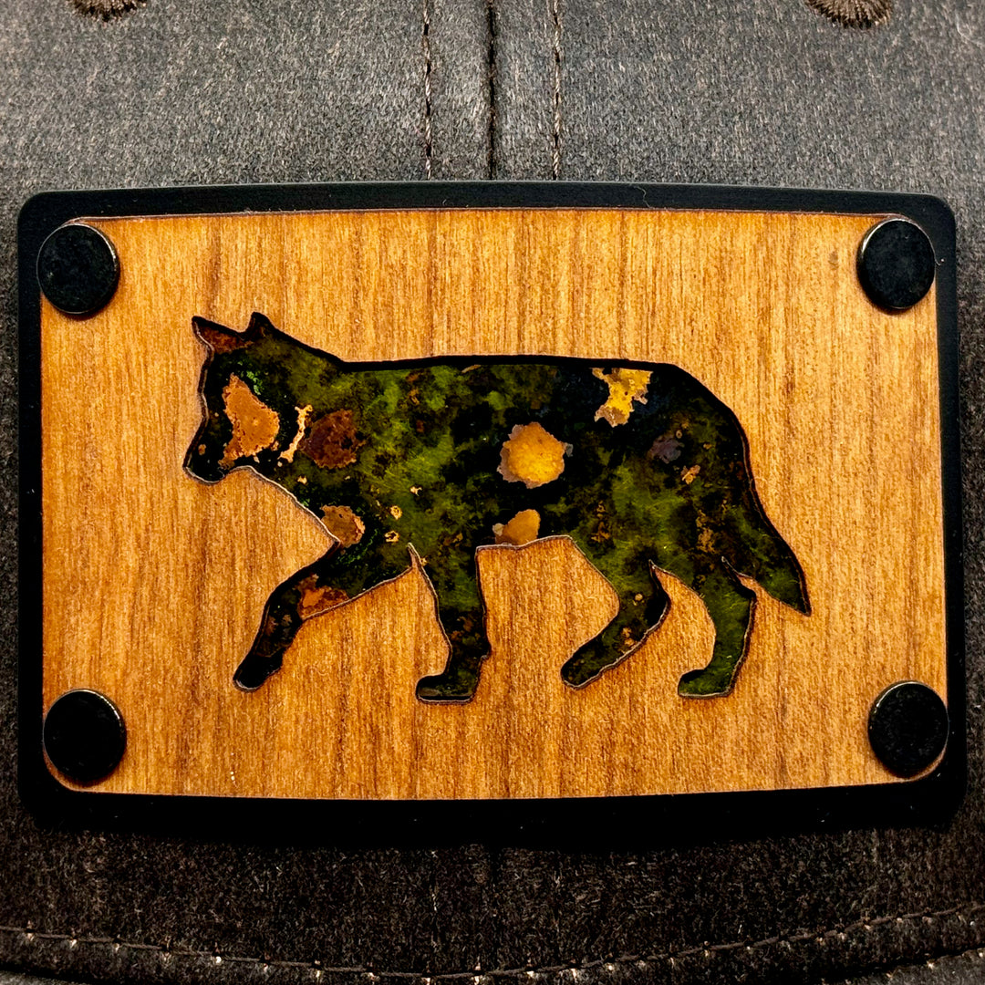 Last Best Supply Co's Cherry Wood & Green Copper Wolf Patch Plate Mossy Oak Trucker Hat (patch detail 2)