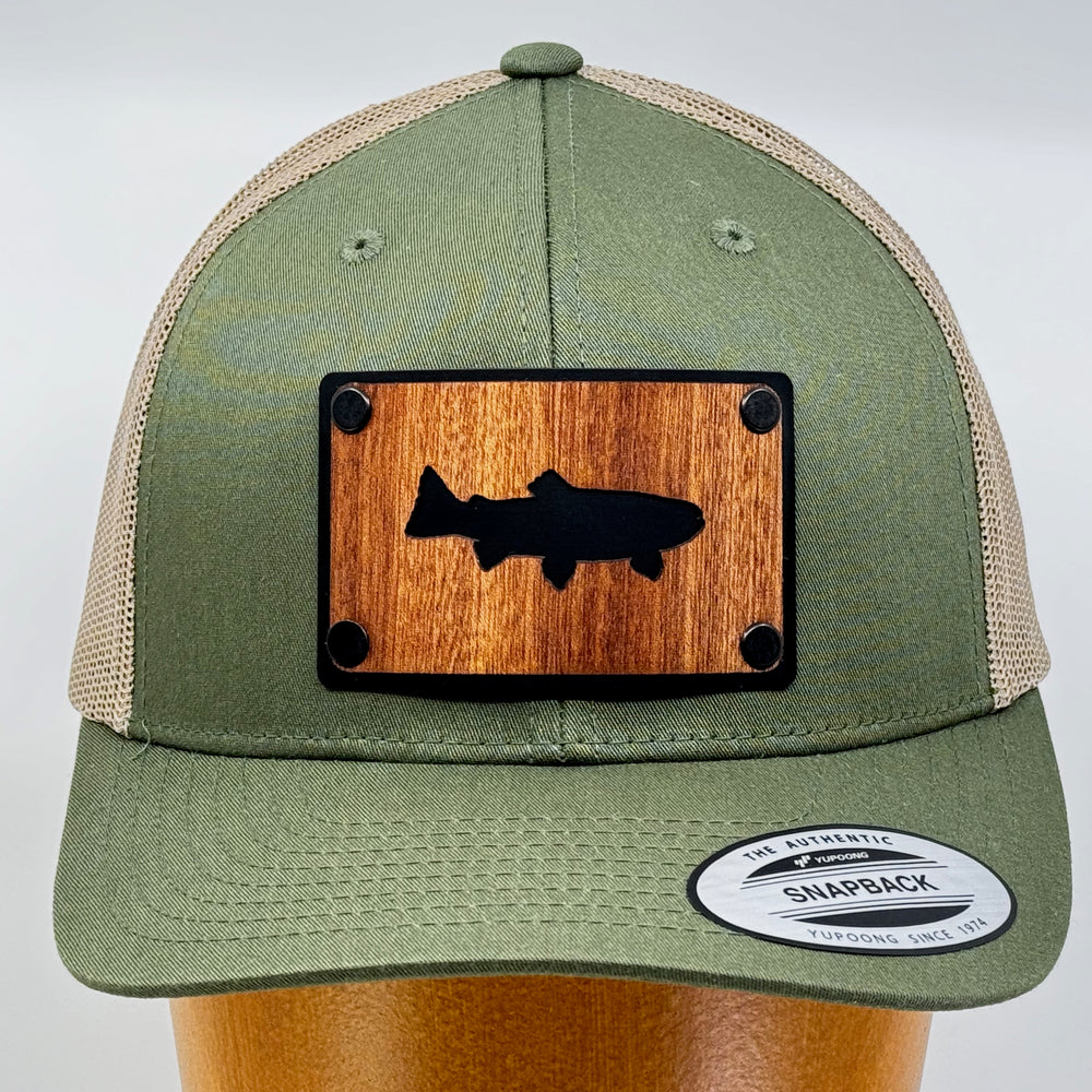 Last Best Supply Co's Olive Green & Khaki Mesh Mahogany Patchplate Trout Silhouetted Trucker Hat, featuring the silhouette of a trout cut out of mahogany against a black metal patch (front view)