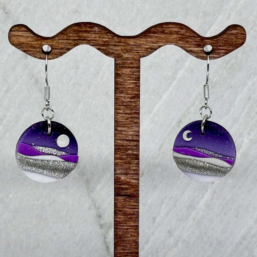 Pair of La Petite Rose's Purple Sun Moon Landscape Clay Earrings, hanging