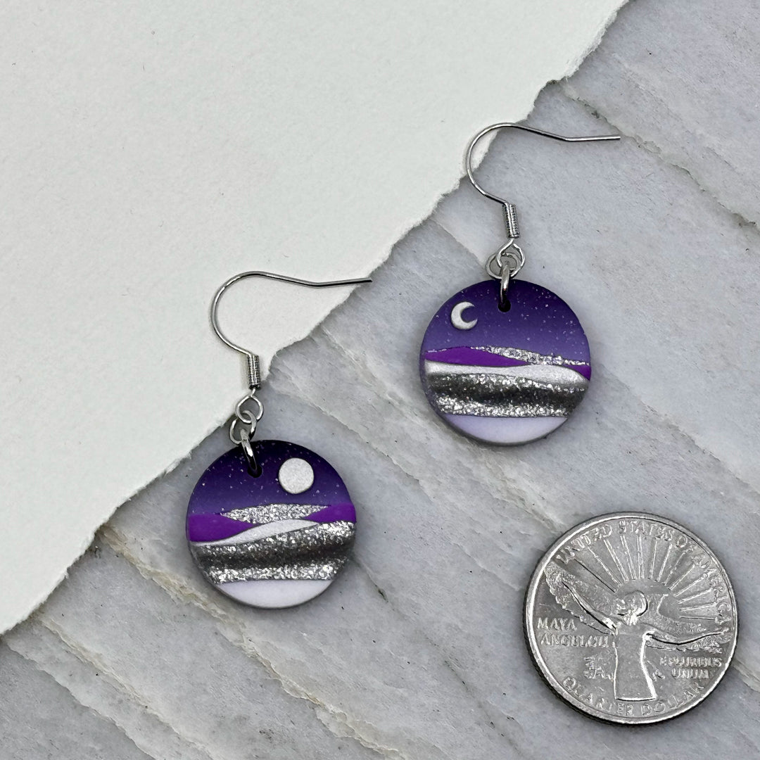 Pair of La Petite Rose's Purple Sun Moon Landscape Clay Earrings, with scale