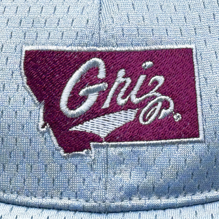 Blue Peak Creative's silver Youth Pro Mesh Hat embroidered with the Griz over Montana design in silver and maroon (detail)