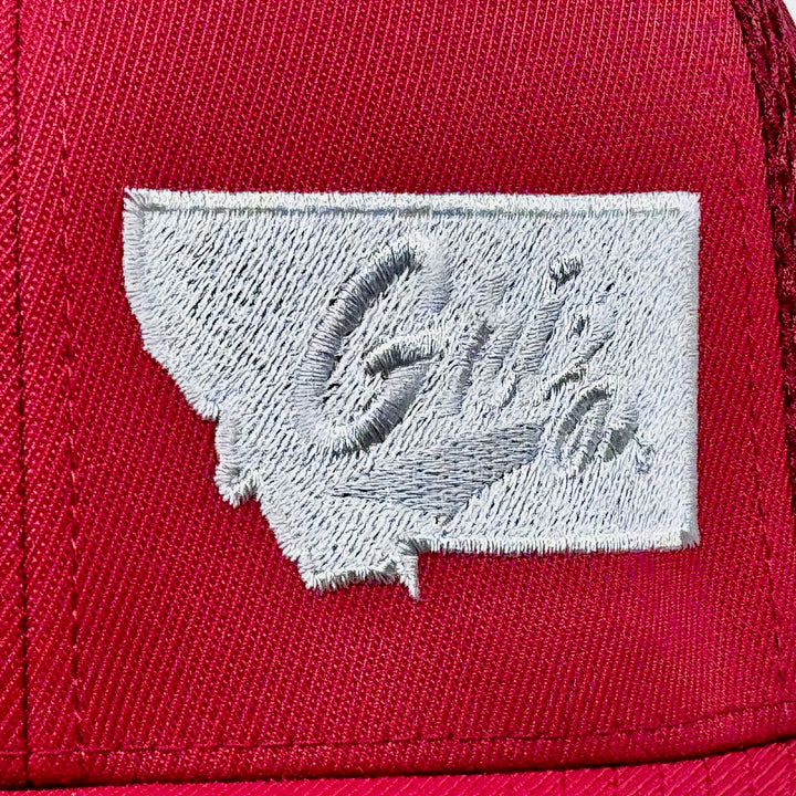 Blue Peaks Creative's maroon Ultrafibre and Airmesh Hat embroidered with the Griz over Montana design in silver (detail)