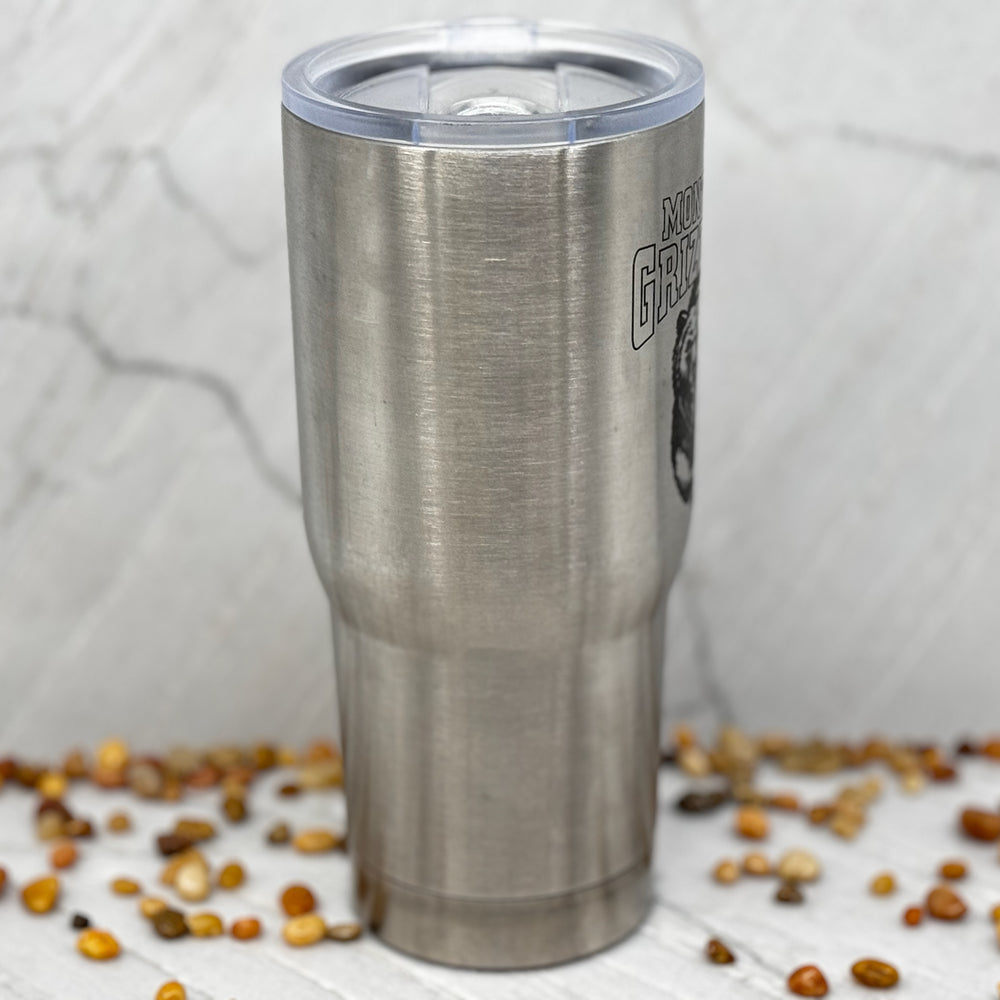Blue Peak Creative's Silver 22oz Stainless Steel Tumbler decorated with the Montana Grizzlies Charging Bear design in black (side)