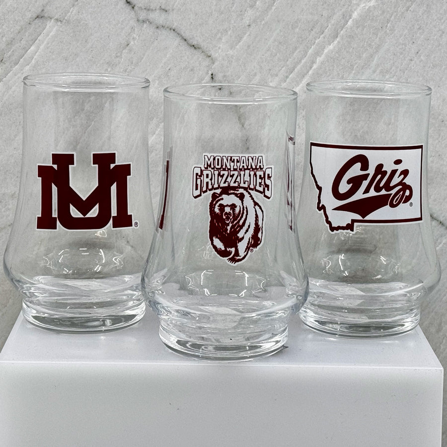 Blue Peak Creative's Montana Grizzlies Glen Cairn Whiskey Glasses - Glen Cairn Whiskey Glasses decorated with University of Montana designs (UM, MT Grizzlies Charging Bear, and Griz Script over state)