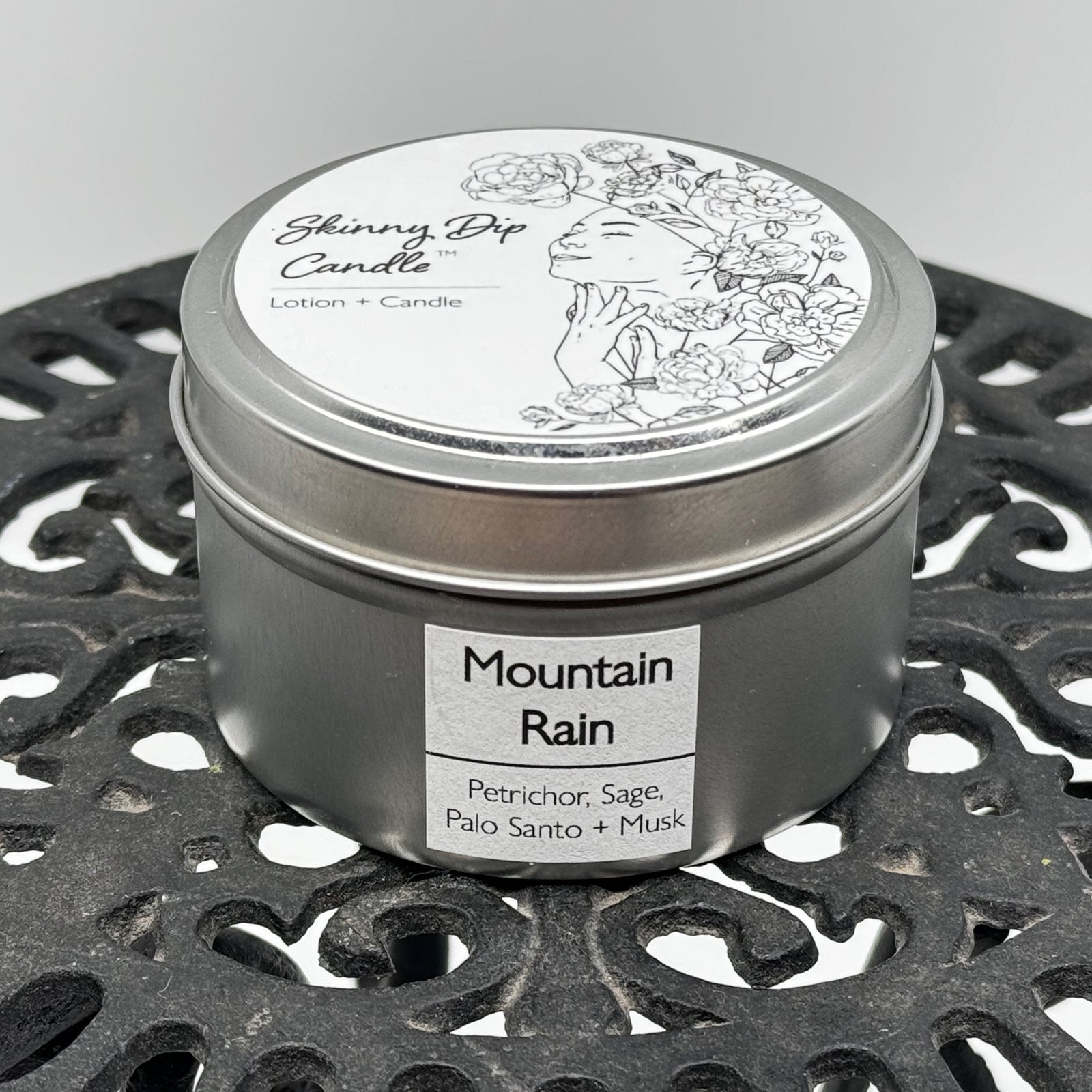 4 oz. tin of Skinny Dip Candle's Mountain Rain Lotion Candle, front