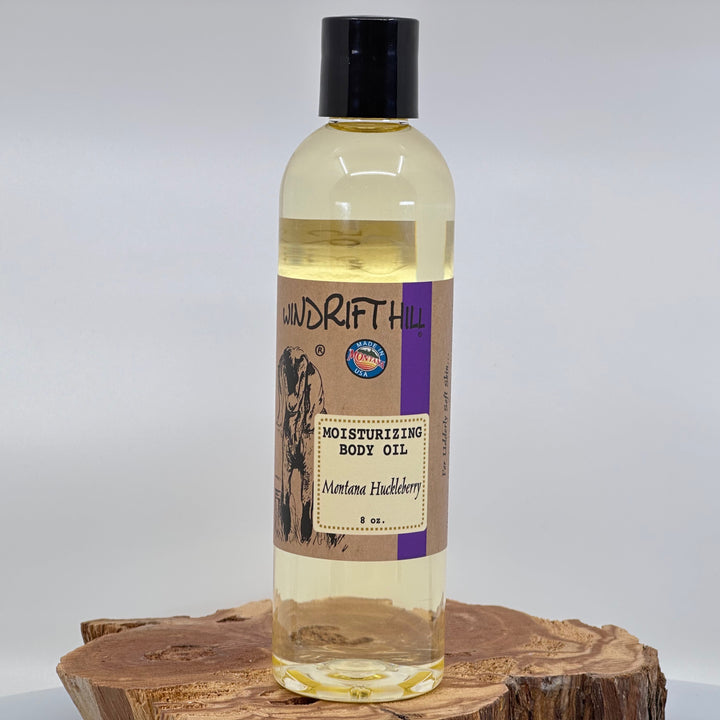 8 oz. bottle of Windrift Hill's Montana Huckleberry Moisturizing Body Oil, front