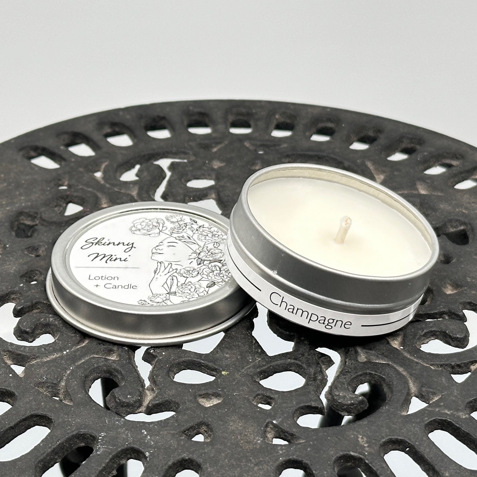1 oz. tin of Skinny Dip Candle's Champagne Lotion + Candle, front