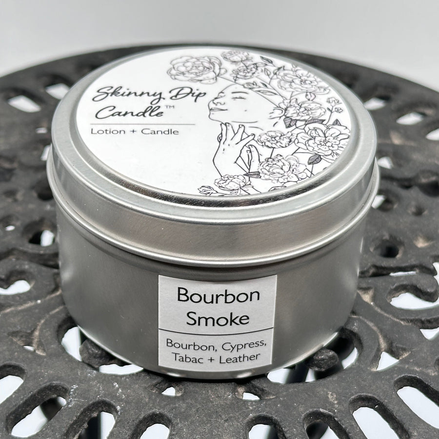 4 oz. tin of Skinny Dip Candle's Bourbon Smoke (bourbon, cypress, tabac, & leather) Lotion + Candle, front