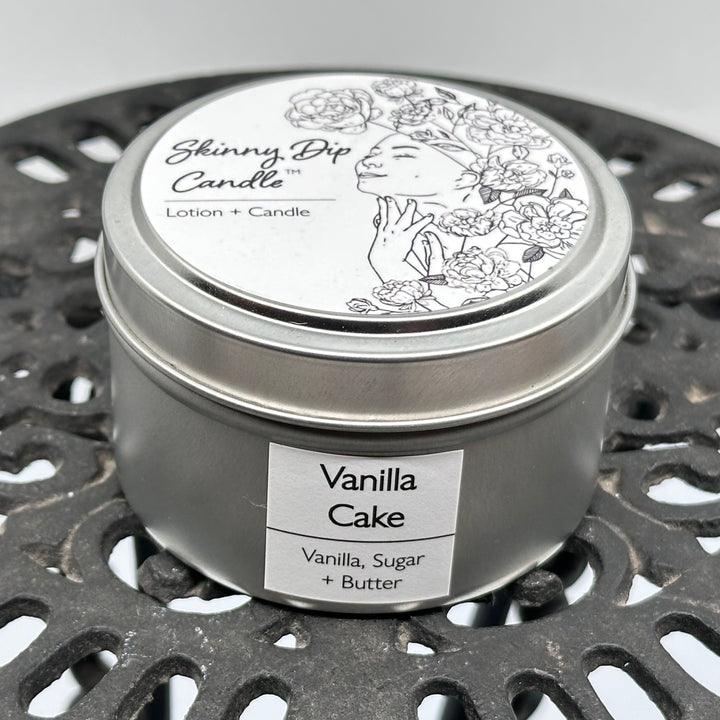 4 oz. tin of Skinny Dip Candle's Vanilla Cake (vanilla, sugar & butter) Lotion + Candle, front