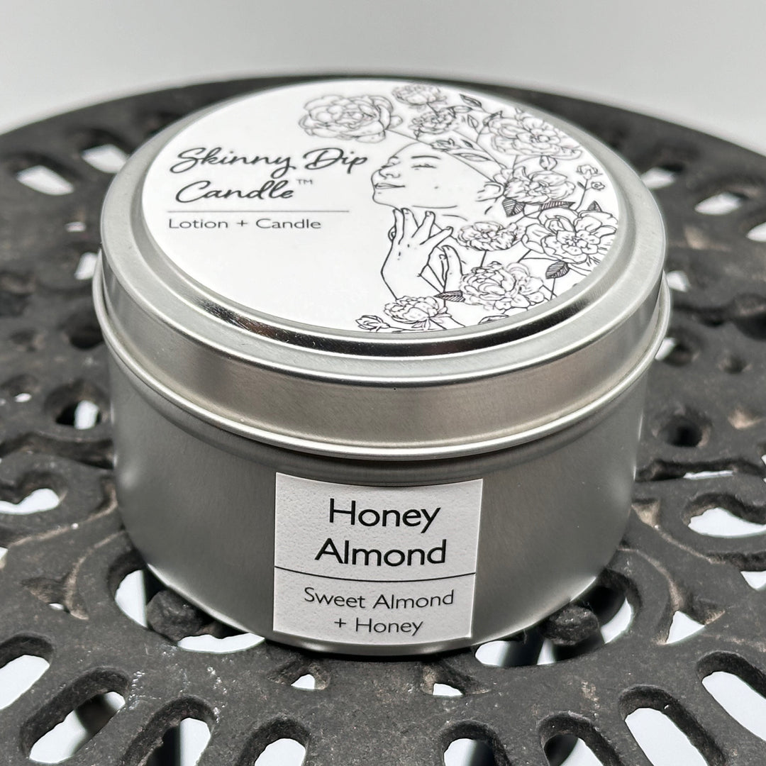4 oz. tin of Skinny Dip Candle's Honey Almond Lotion + Candle, front