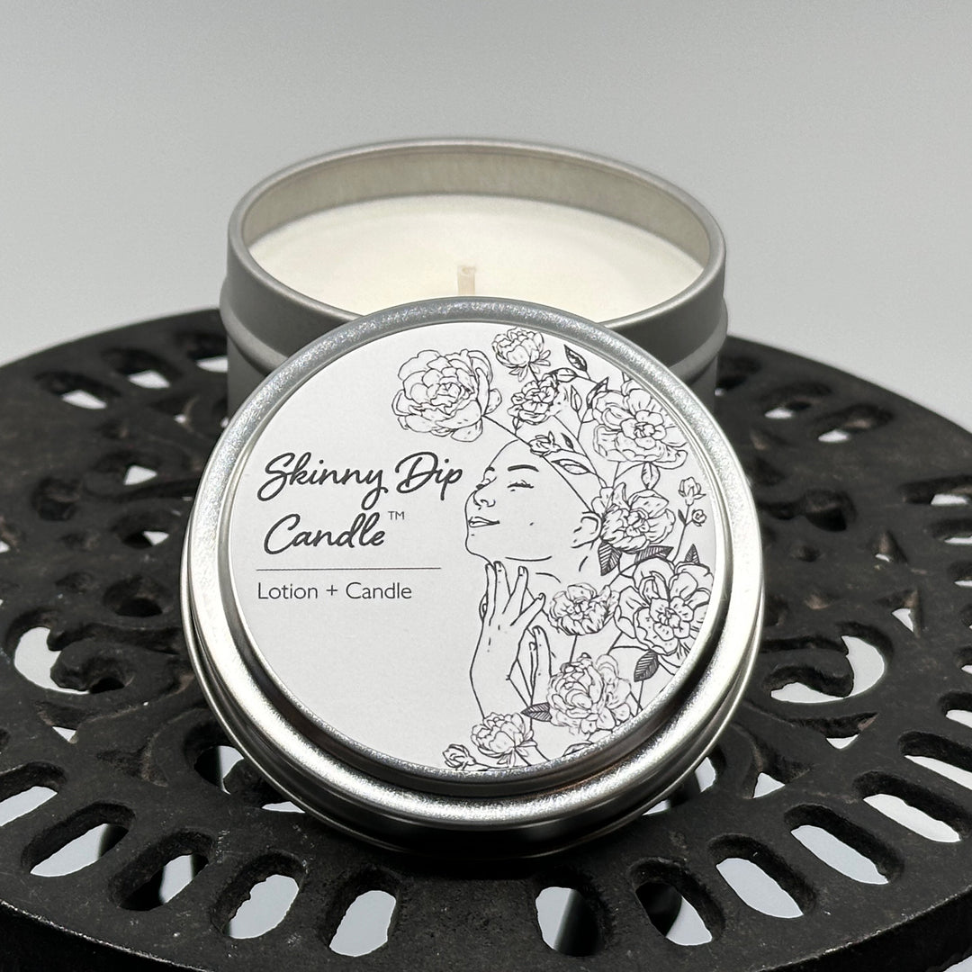 4 oz. tin of Skinny Dip Candle's Bare Naked (unscented) Lotion + Candle, lid & inside