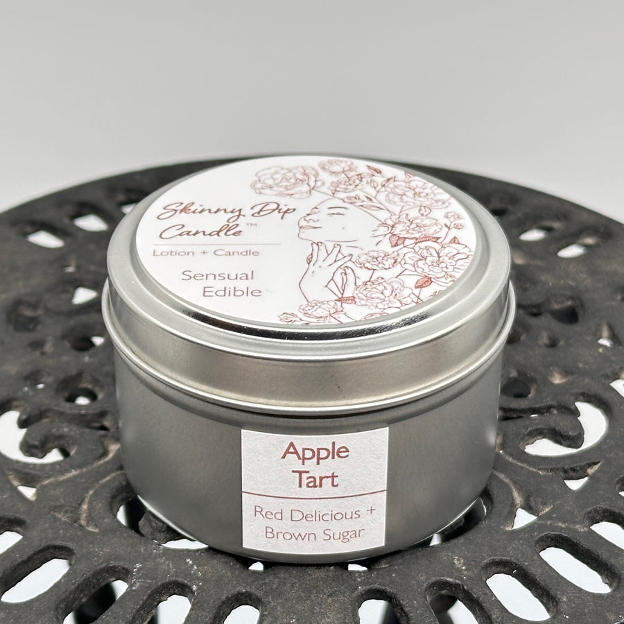 4 oz. tin of Skinny Dip Candle's Apple Tart (red delicious & brown sugar) Lotion + Candle, front