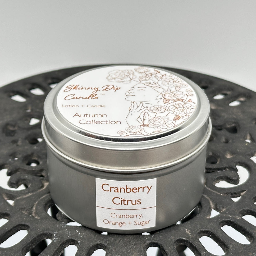 4 oz. tin of Skinny Dip Candle's Cranberry Citrus (cranberry, orange & sugar) Lotion + Candle, front