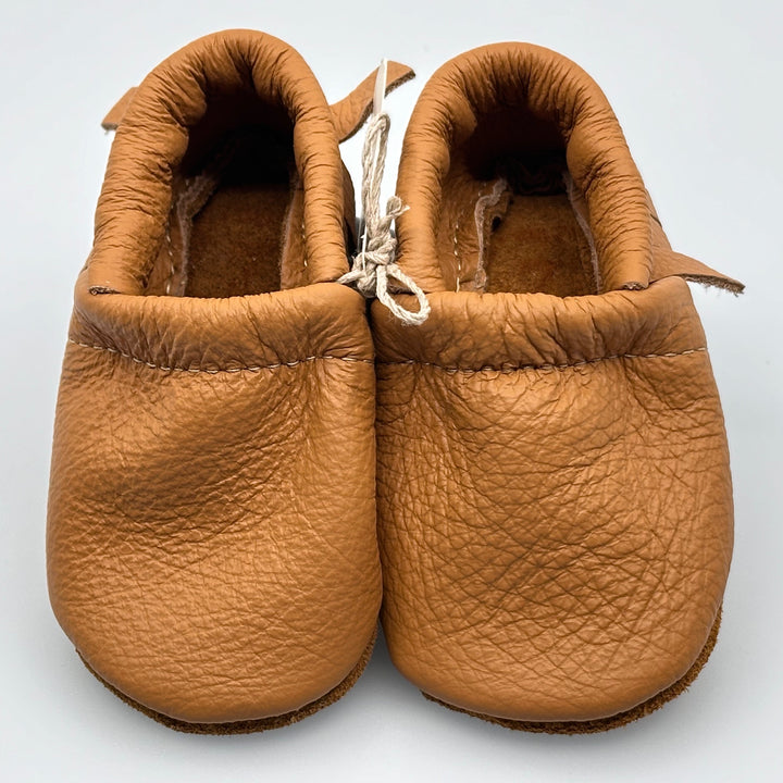 Pair of Starry Knight Design leather moccasins / baby booties, camel tan with fringe, front