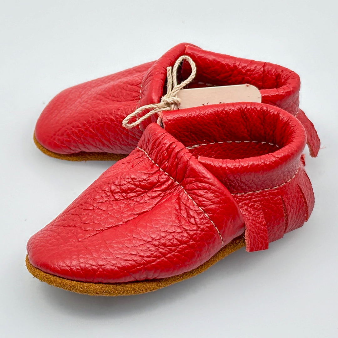 Pair of Starry Knight Design leather moccasins / baby booties, cherry red with fringe, side