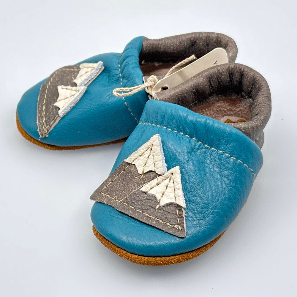 Pair of Starry Knight Design leather moccasins / baby booties, azure & cerulean with mountain design, side