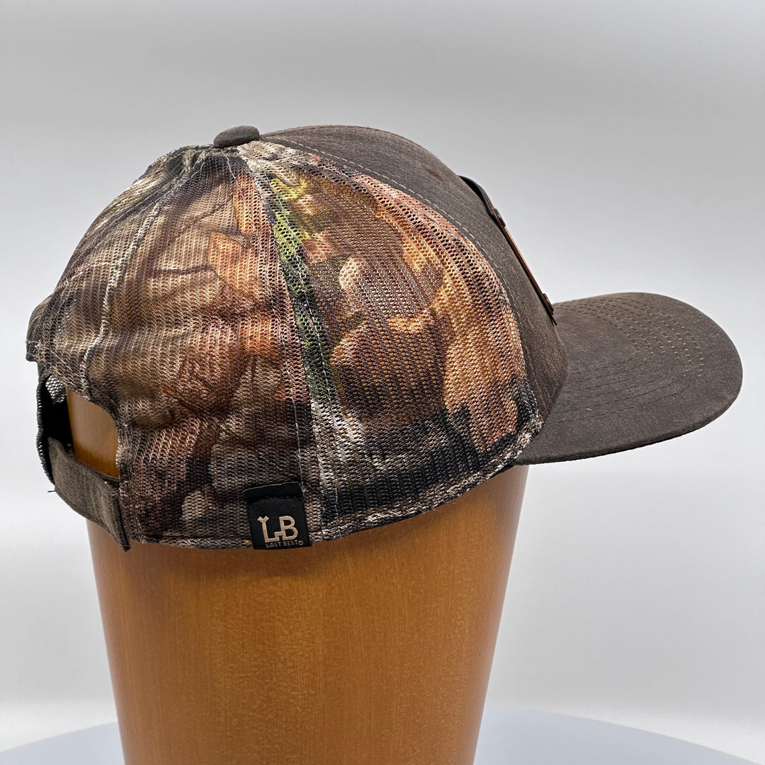 Last Best Supply Co's Cherry Wood & Green Copper Wolf Patch Plate Mossy Oak Trucker Hat (rear view)