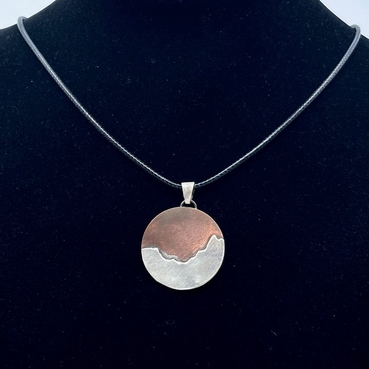 Bull & Bear's Copper and .925 Sterling Silver Montana Mountain Pendant, featuring Many Glacier, on a black cord