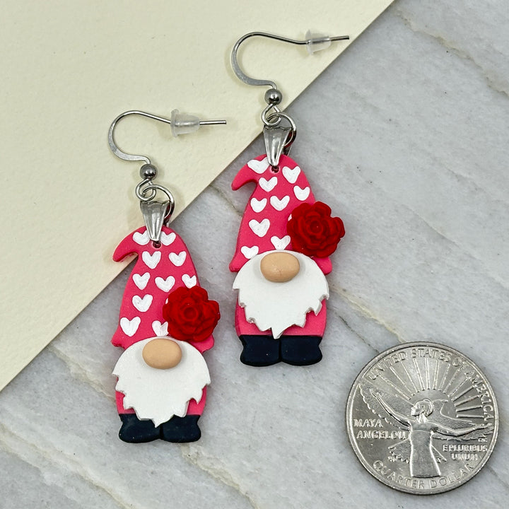 Pair of Bitterroot Shining Creations' Valentine Earrings (gnomes), with scale