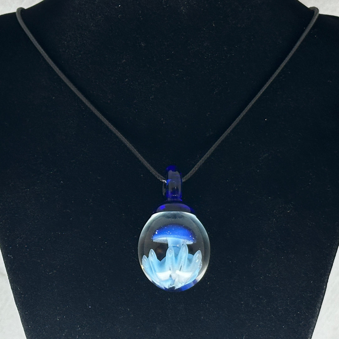 Hand Blown Mushroom Pendant (borosilicate lampwork) by Blue Flame Glass on cord (single mushroom, blue cap blue grass), hanging