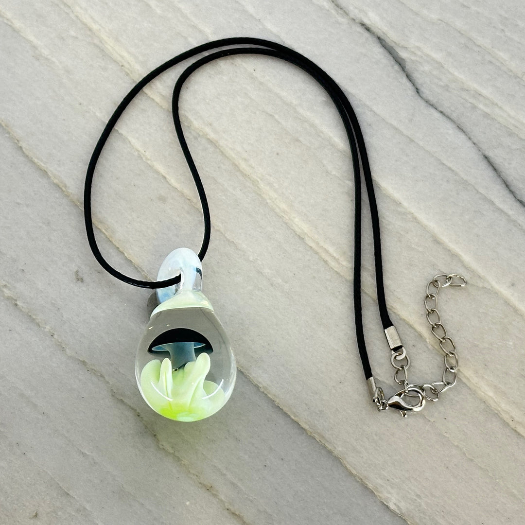 Hand Blown Mushroom Pendant (borosilicate lampwork) by Blue Flame Glass on cord (single mushroom, black cap and light green grass)