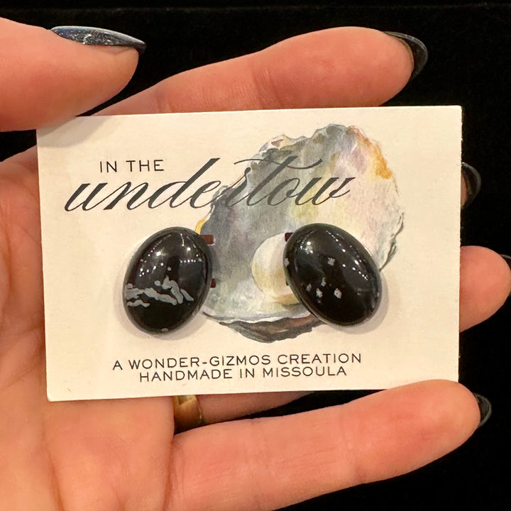Black oval jasper stone cuff links on a card that reads Handmade in Missoula