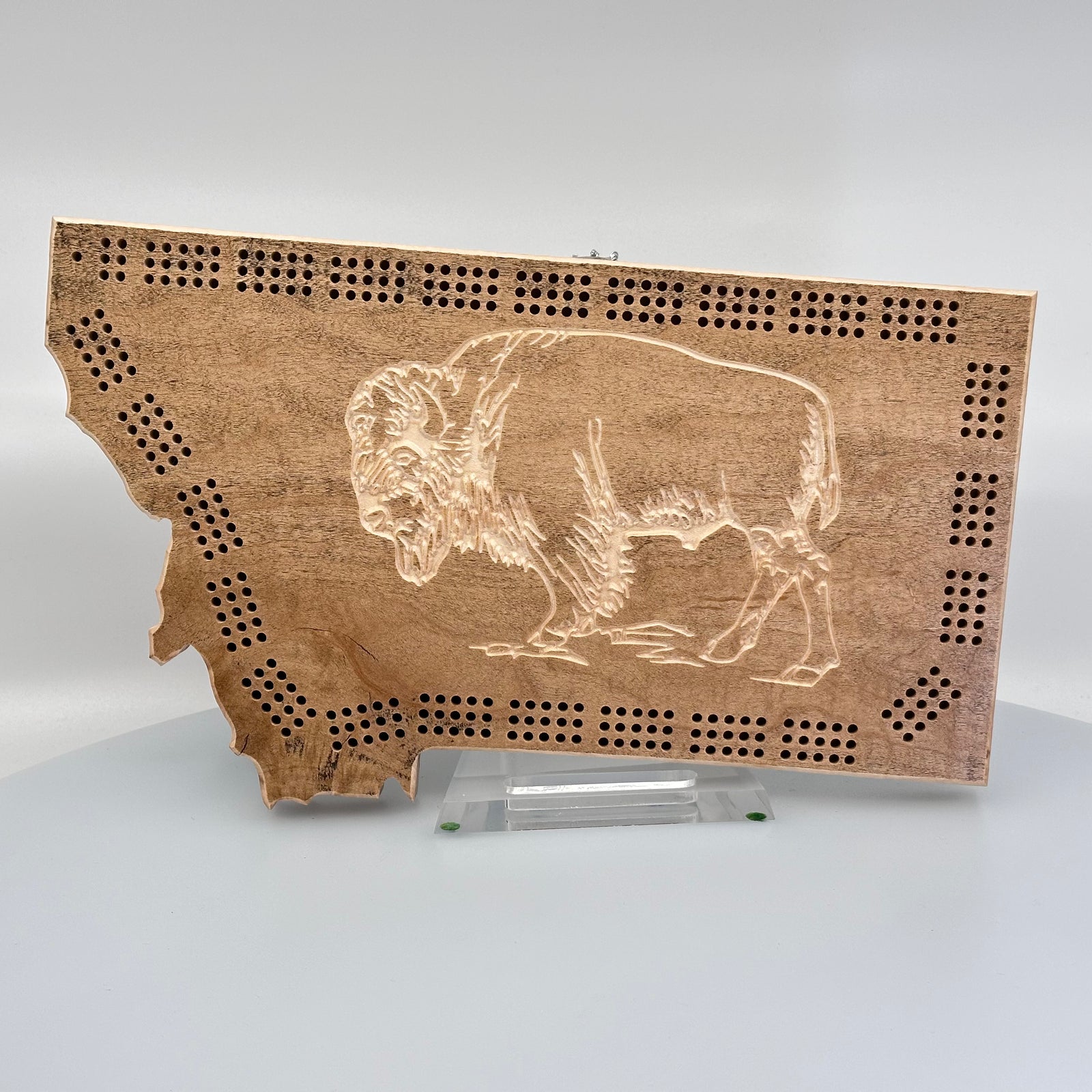 Knotty Pine Woodworks Handmade Montana Bison Cribbage Board (front)--this made in Montana wood cribbage board is in the shape of Montana light espresso with natural wood accents, and features a detailed bison engraved in the front.