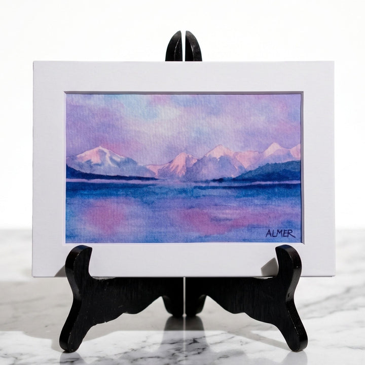 Bring Glacier National Park home with the Lake McDonald Sunset Matted Print by Stark Mountain Studio. A colorful Bobbe Almer watercolor reproduction.